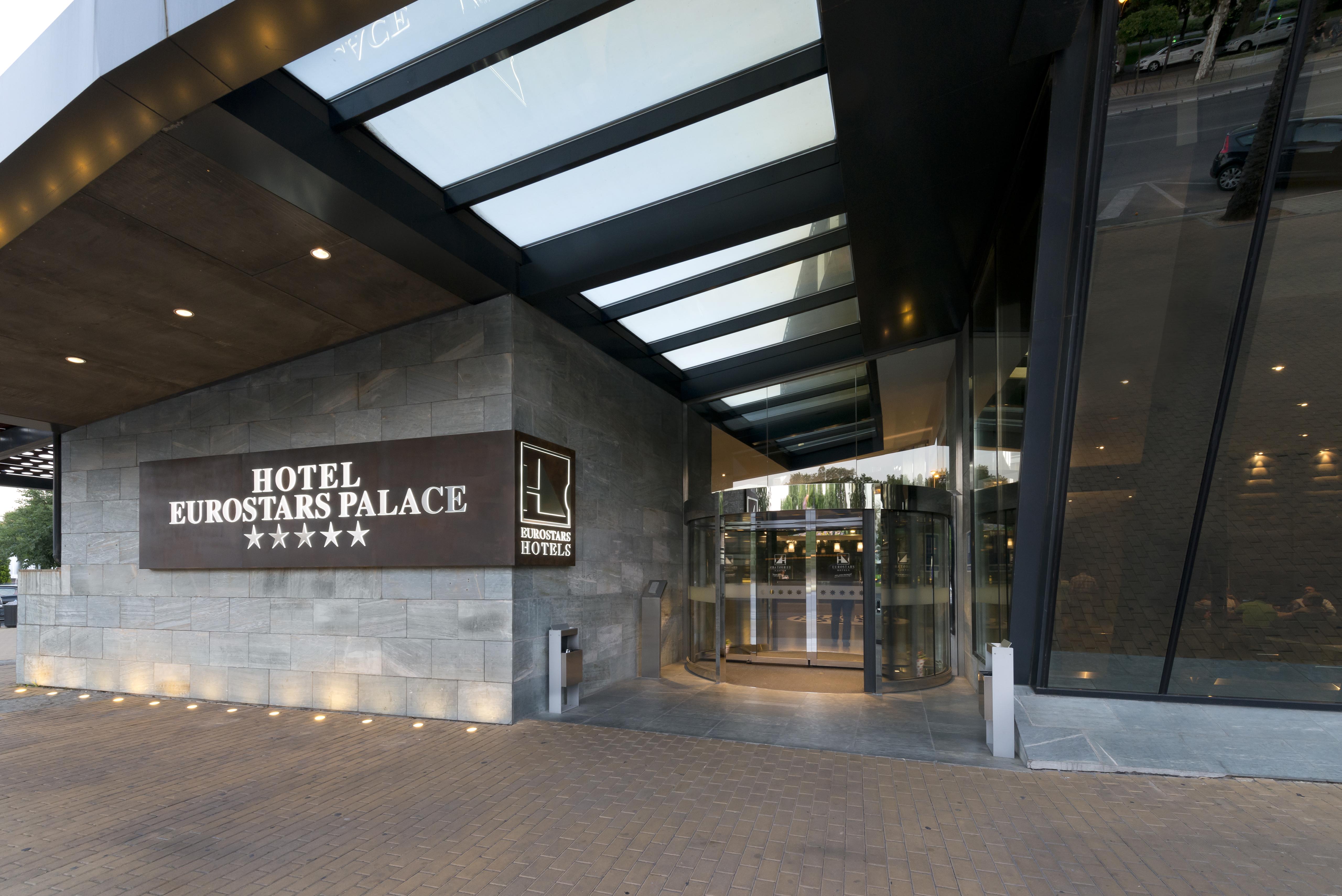 Eurostars Palace Cordoba Luaran gambar The photo shows the entrance of the Eurostars Palace Hotel, which features a modern design. The entrance is characterized by a glass revolving door and a prominent sign that displays the hotel's name and five-star rating. The exterior has a combinati